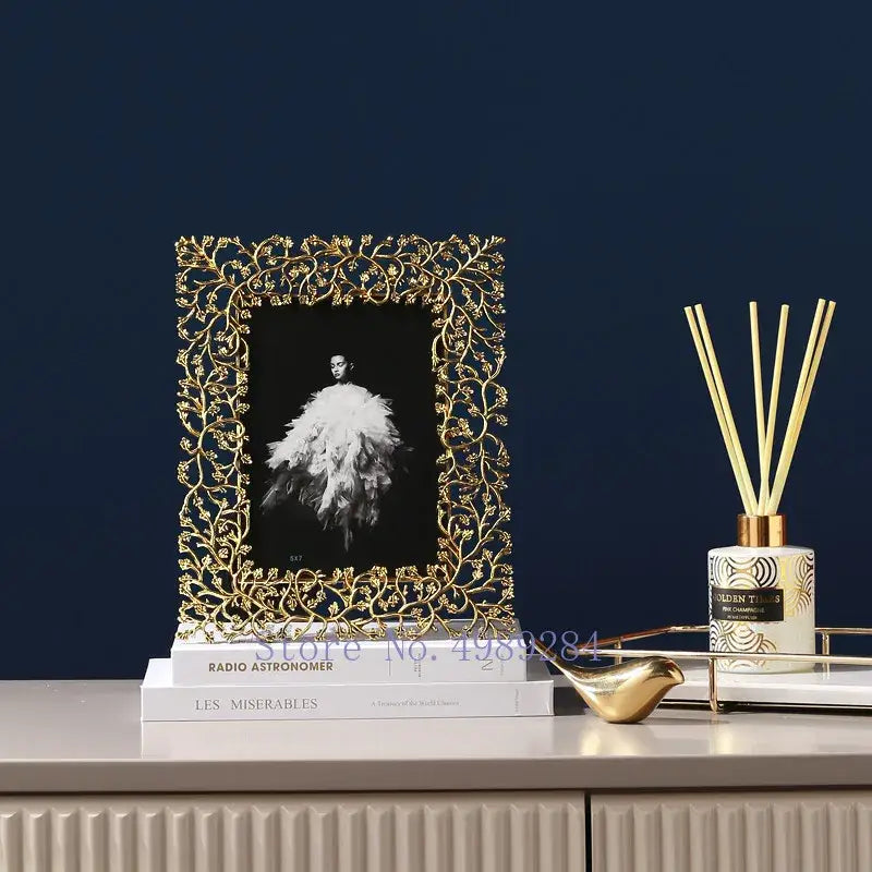 Ornate golden leaves metal photo frame with intricate leaf and vine detailing holding a black and white portrait decorbites golden leaves