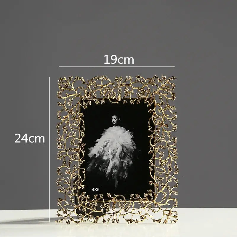 Ornate gold-toned metal photo frame with intricate vine and leaf detailing decorbites golden leaves metal decor