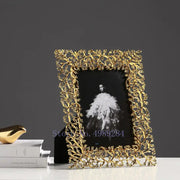 Ornate golden leaves metal photo frame with intricate leaf and vine detailing for living room decor by decorbites