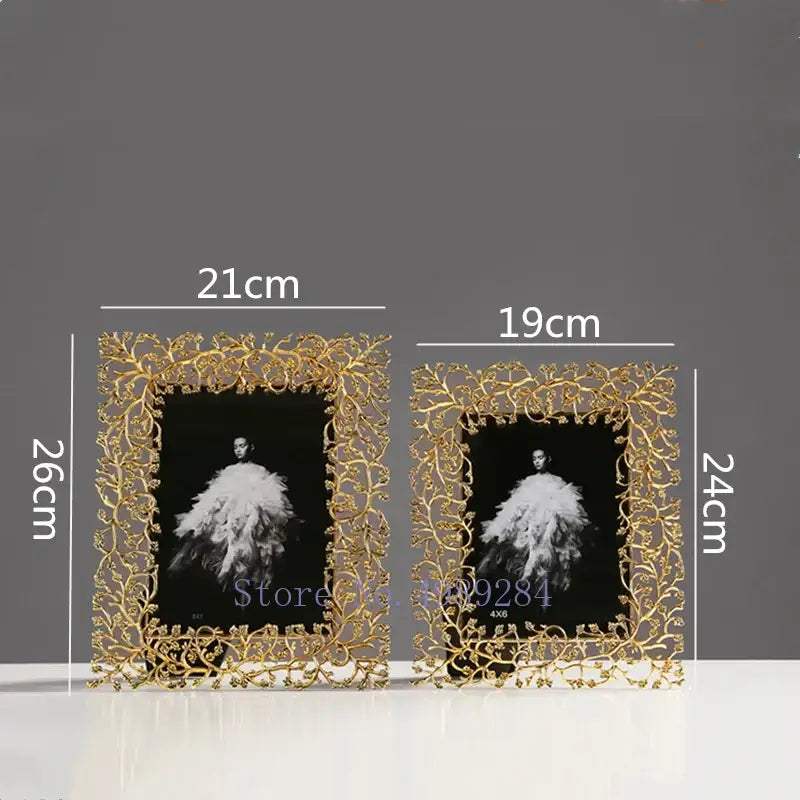 Two ornate gold-toned photo frames with intricate golden leaves metal vine decorbites golden leaves design for living room decor