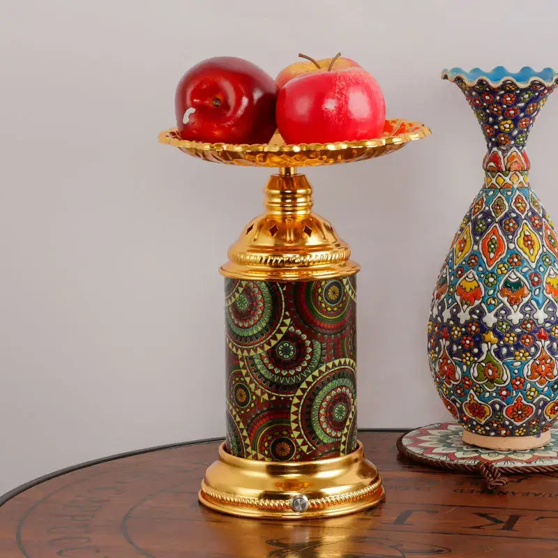 Ornate golden mosaic fruit platter desk lamp with decorative cylindrical body holding red apples for decorbites fruit platter