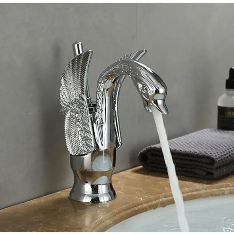 Ornate golden solid brass basin faucet with chrome finish ceramic valve core and swan-shaped detailed feathered wings