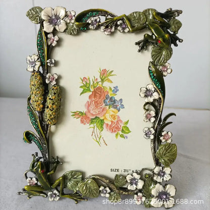 Ornate green and gold metal photo frame with detailed frog metal figures and gemstone accents for living room decorbites frog metal decor