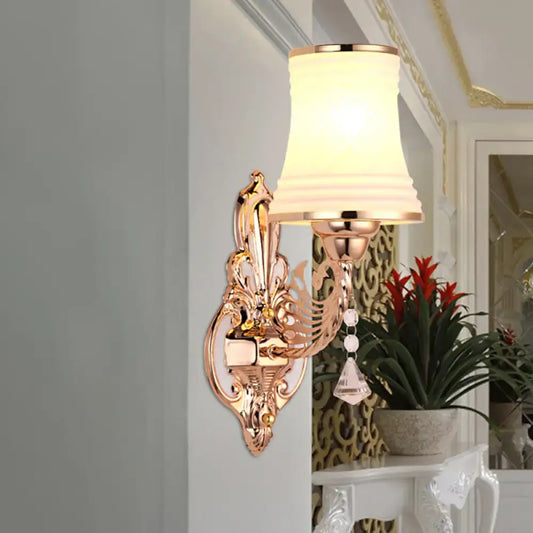 Ornate rose gold tapered bell wall sconce with opal glass tapered shade and crystal accents for bedroom lighting
