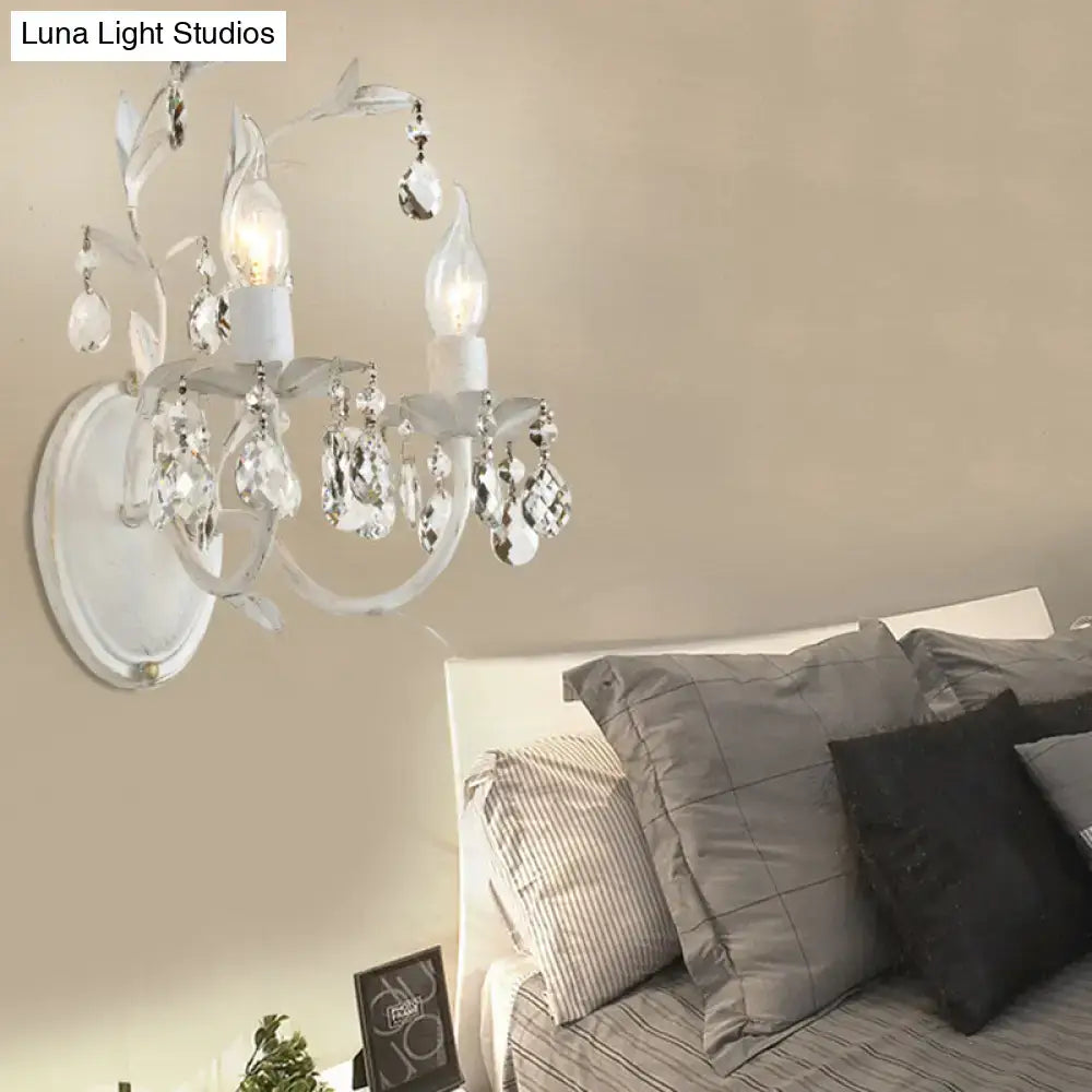 Ornate silver crystal leaf wall light fixture with delicate white crystal chandelier and clear glass accents for bedroom sconce