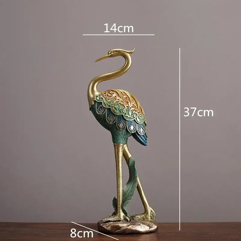 Ornate teal and gold crane bird sculpture with floral patterned wings on bronze base for living room decorbites crane bird decor