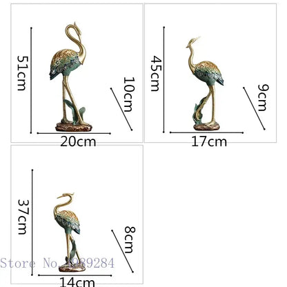 Three ornate teal and gold metallic crane bird sculptures with intricate feather detailing for living room decor