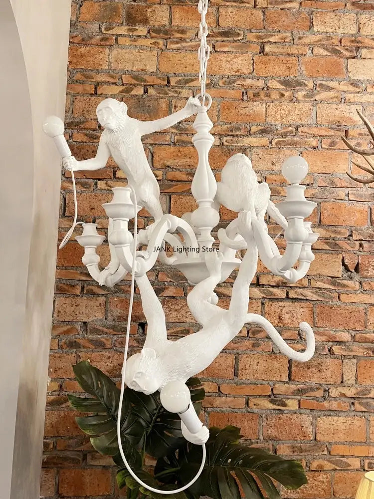 Ornate white monkeys pendant chandelier with sculpted figures and candle-style arms for living room decor