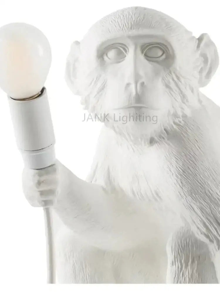 Ornate white ceramic monkeys pendant chandelier featuring a monkey lamp holding a bulb for living room decor
