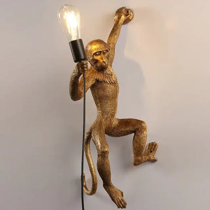 Ornate white monkeys pendant chandelier featuring a golden monkey wall lamp holding a lit bulb for living room decor