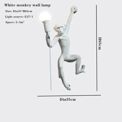 Ornate white monkeys pendant chandelier featuring a matte white resin monkey wall lamp holding an illuminated torch for decor