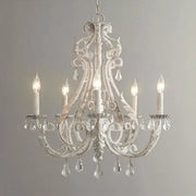 Ornate white decorbites iron crystal chandelier with intricate wrought iron detailing and crystal droplets for living room