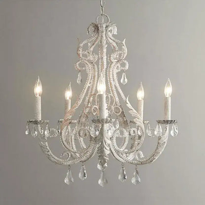 Ornate white decorbites iron crystal chandelier with intricate wrought iron detailing and crystal droplets for living room