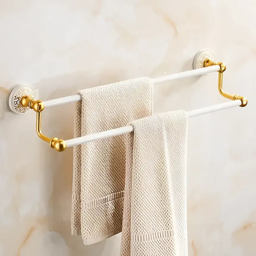Ornate white and gold double towel rack with decorative ends in the decorbites bath hardware set for bathroom decor