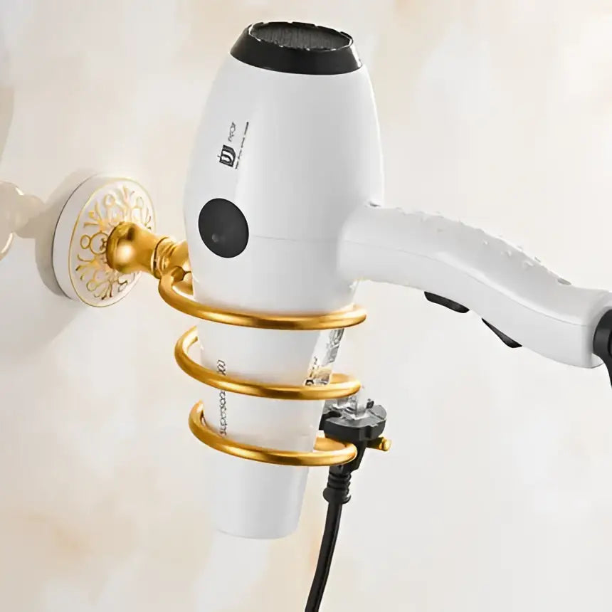 Ornate white and gold decorbites bath hardware set featuring a white hair dryer with black accents and a gold wall holder