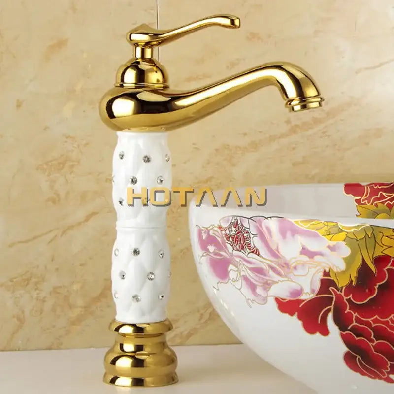 Ornate white and gold brass decorbites basin faucet with crystal-embedded ceramic spout and quilted detailing for bathroom sink