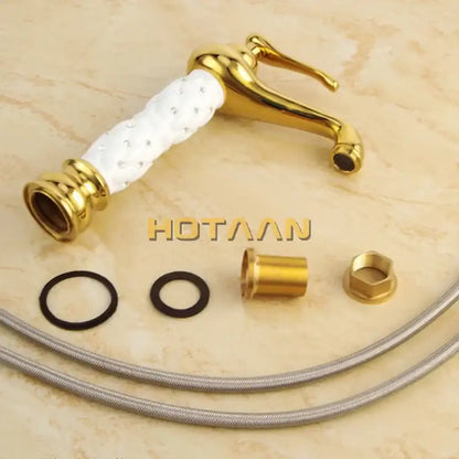 Ornate white and gold brass basin faucet with textured ceramic handle and embedded crystals decorbites basin faucet
