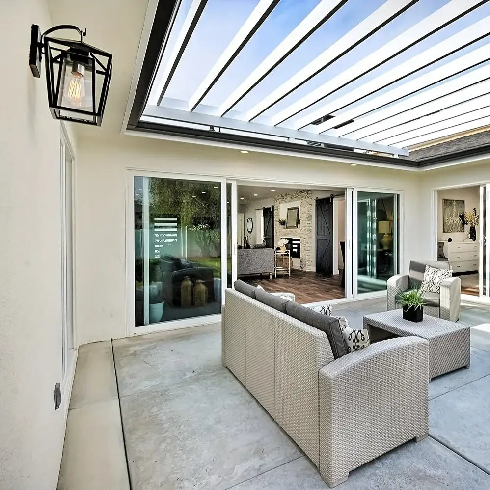 Beige woven wicker sectional sofa with gray cushions next to decorbites™ waterproof outdoor wall light with glass shades