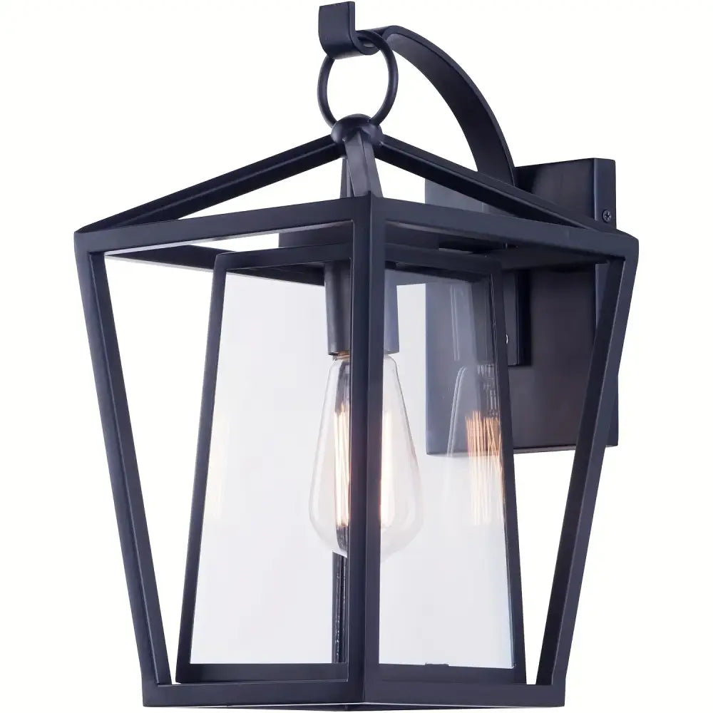 Black wrought iron outdoor wall light with glass shades featuring clear panels and an exposed filament bulb