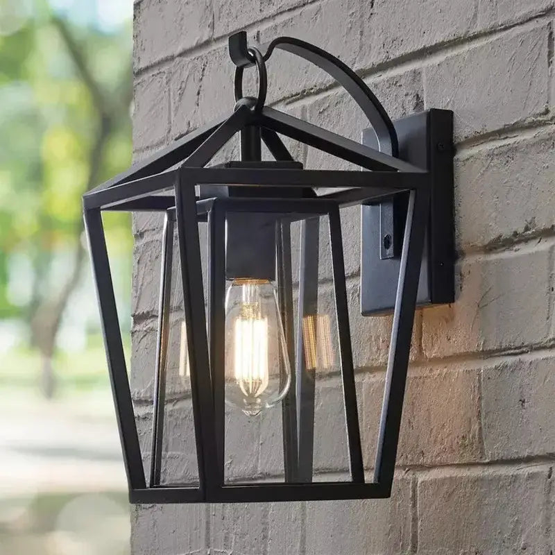 Black wrought iron outdoor wall light with glass shades and exposed filament bulb by DecorBites waterproof design