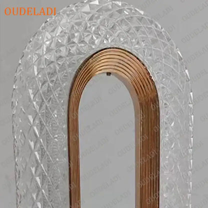 A clear arched mirror with faceted crystal frame and polished copper border complements decorbites crystal bedroom table lamp
