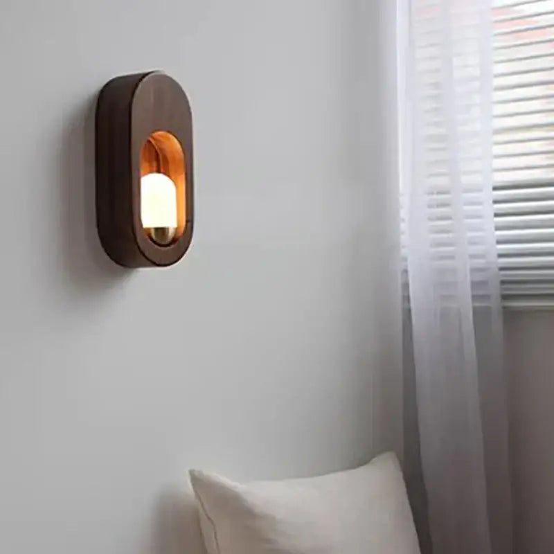 Dark wood oval led wooden wall lamp with warm amber light for bedroom decorbites led wooden wall sconce