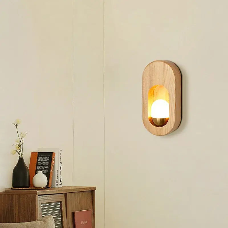 Warm-toned oval led wooden wall lamp with smooth natural grain and soft amber glow for bedroom decorbites led wooden sconce
