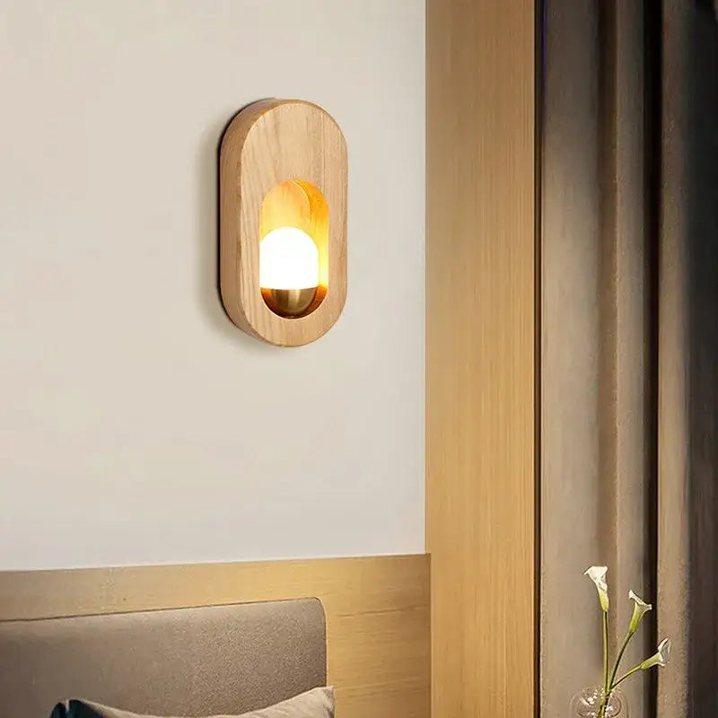 Warm-toned oval led wooden wall lamp decorbites with smooth natural grain and amber light for bedroom decor