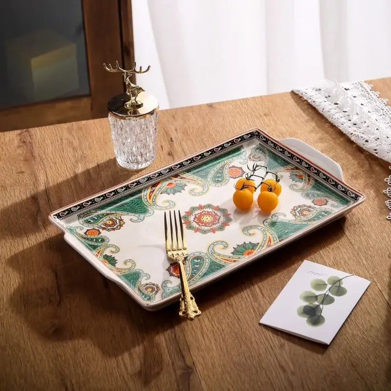Rectangular ceramic ice crack tray with white base, green and orange paisley pattern, black border, and two handles