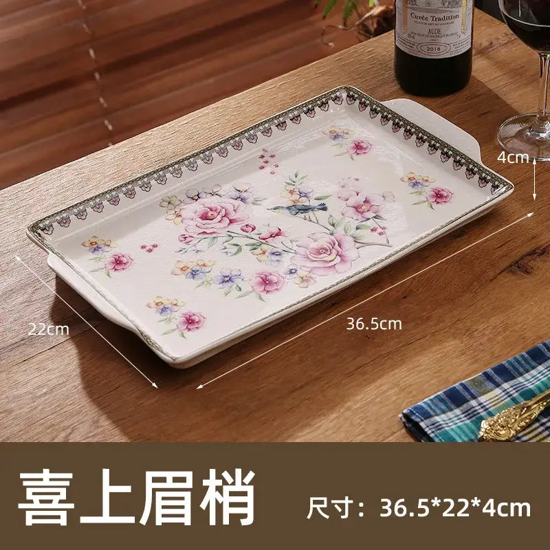 A rectangular white ceramic ice crack tray with pink roses, purple flowers, green foliage, and black lace decorbites ice crack
