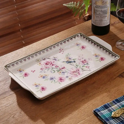 A rectangular ceramic ice crack tray with pink floral pattern and ornate black lace border for decorbites ice crack use