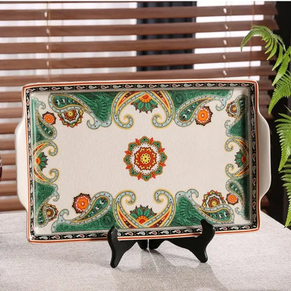 A rectangular ceramic ice crack tray with green and orange paisley patterns and central floral motif for serving