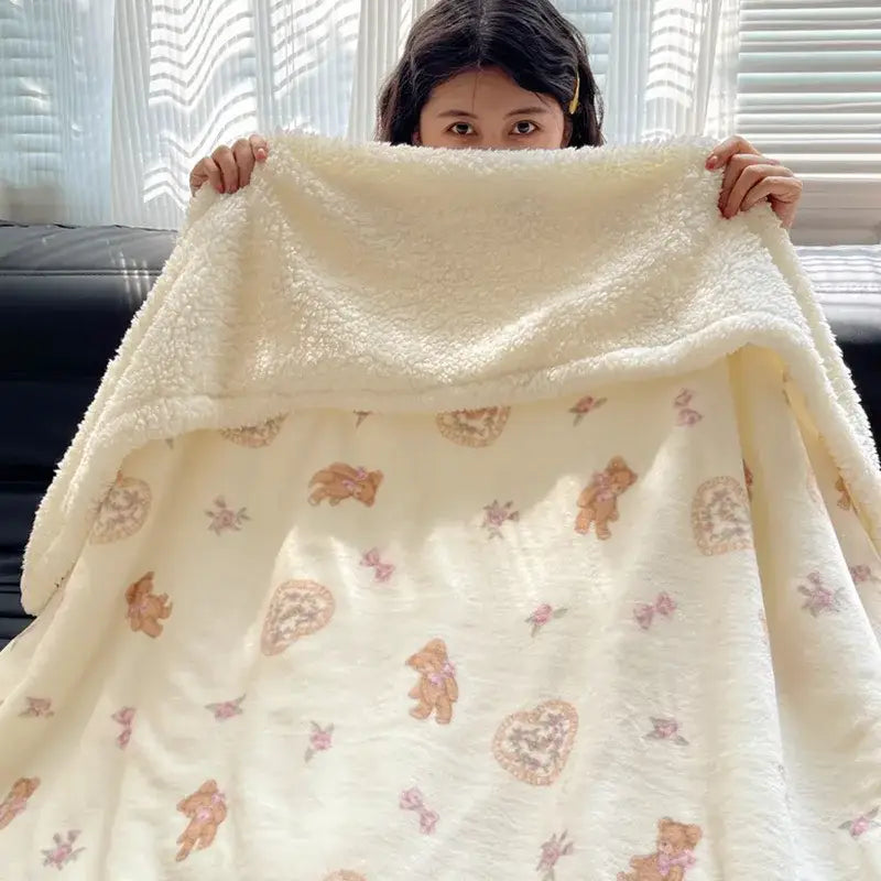 Cream-colored decorbites cozy fleece blanket with brown teddy bears and pink bows soft fuzzy texture bedroom throw