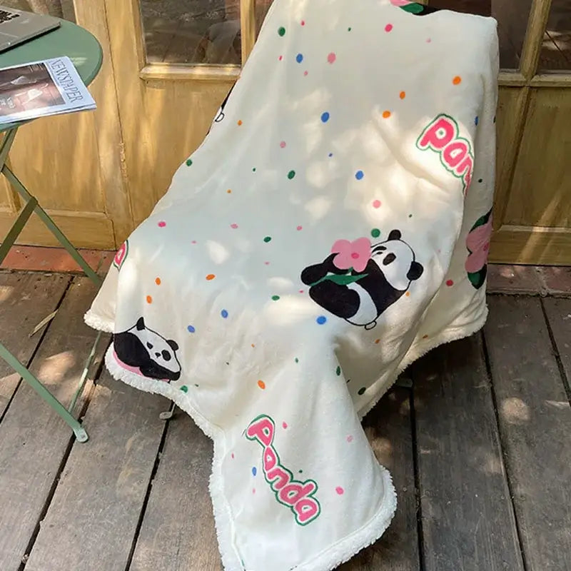 Cream-colored cozy fleece blanket by decorbites with panda illustrations, colorful polka dots, and embroidered panda text