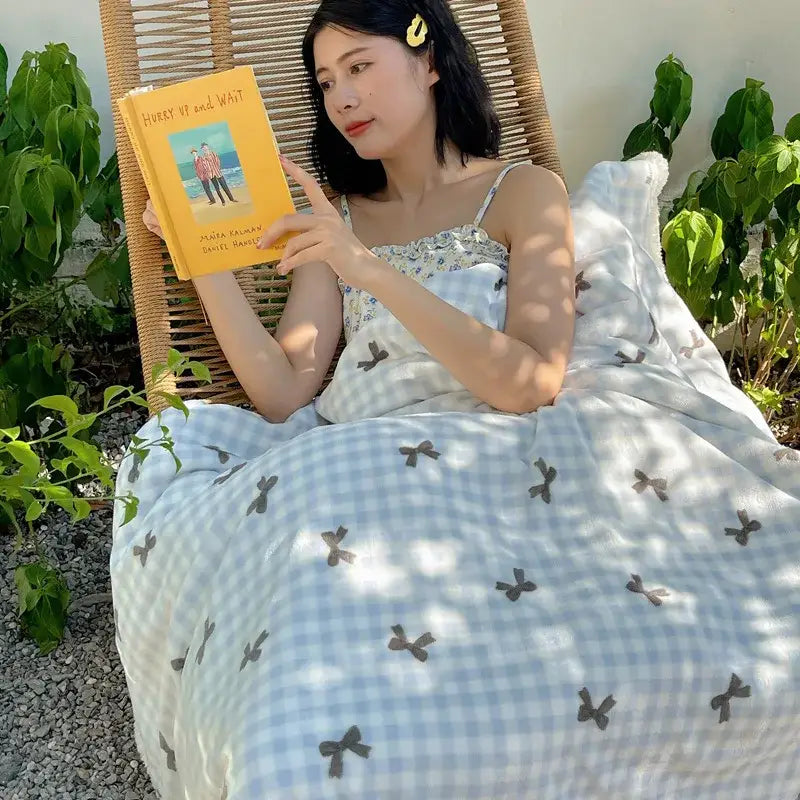 Yellow hardcover book hurry up and wait by mohsin hamid on a panda pattern white decorbites cozy fleece blanket throw
