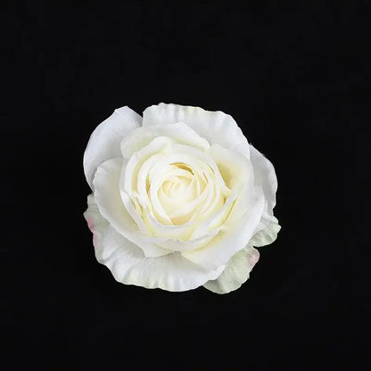 A delicate white silk rose with pale yellow center from 30pcs silk roses set for wedding and living room decor
