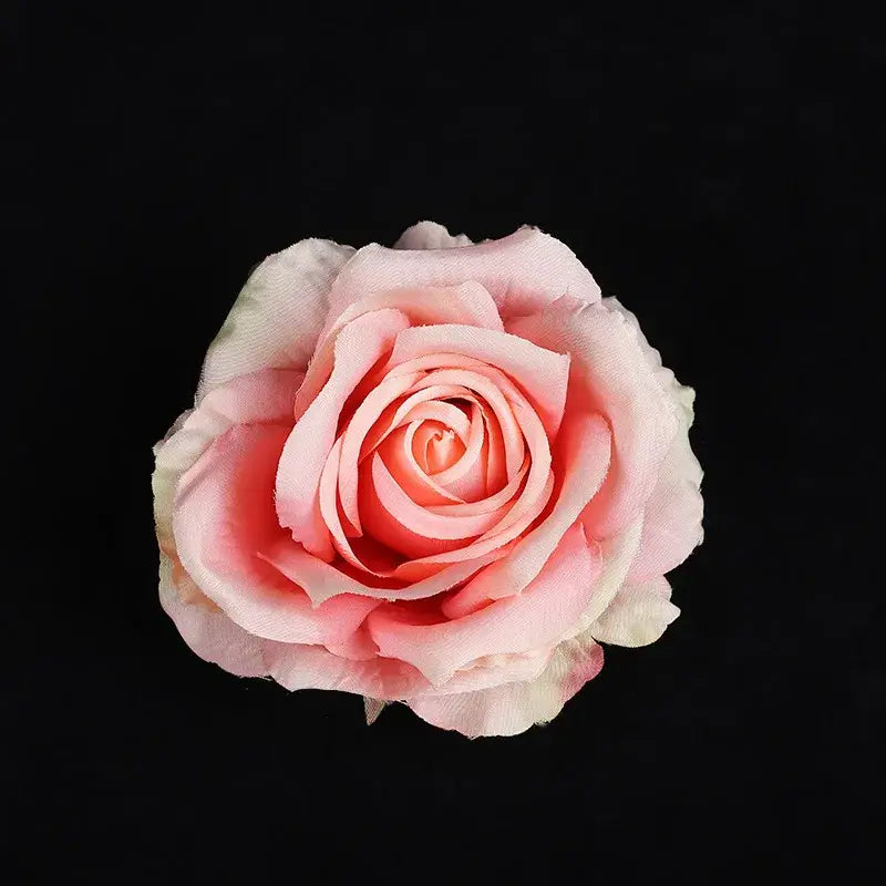A delicate pink silk rose with softly layered petals from the pastel 30pcs silk roses wedding and living room decor set