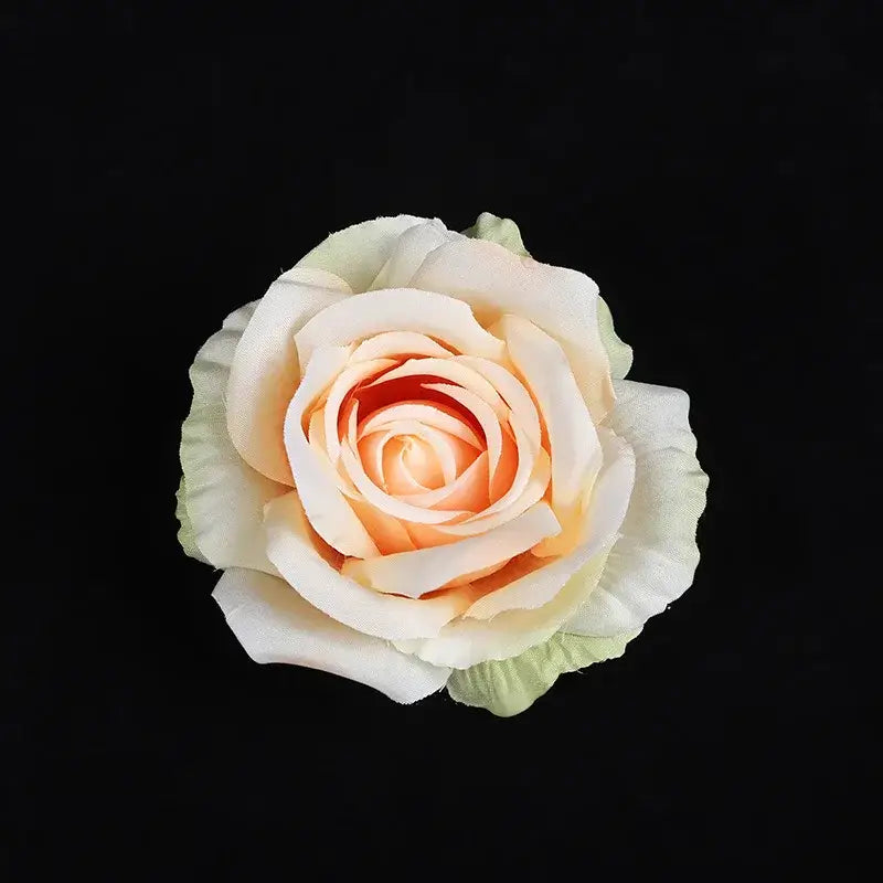 A delicate peach and cream silk rose with soft layered petals from a pastel 30pcs silk roses set for decor