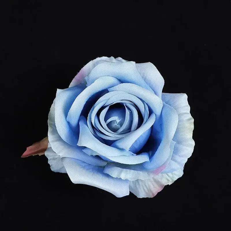 A delicate light blue silk rose with pink and white gradient petals made from soft fabric in a 30pcs silk roses set