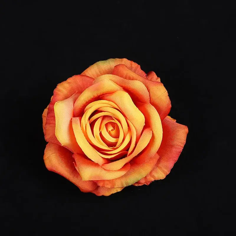 A vibrant gradient orange silk rose with layered petals in realistic fabric from the pastel 30pcs silk roses set