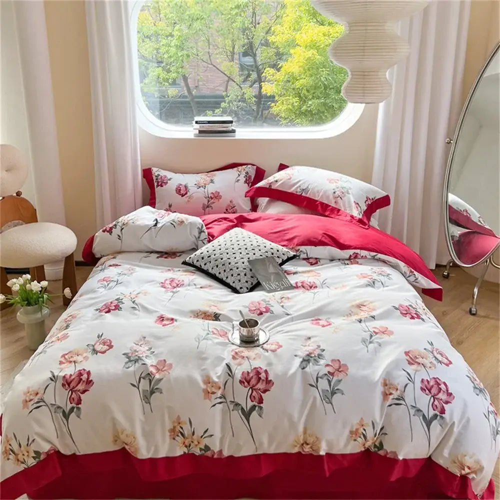 Pastel blue and peach floral bedding set featuring a ruffled duvet cover with pink and peach blossoms on white base