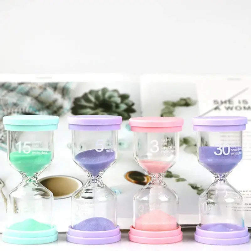 Set of four pastel blue and pink glass sand timers with silicone lids marked for 3, 5, 15, and 30 minutes timer set