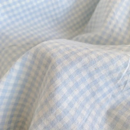 Pastel blue and white gingham cotton fabric with delicate woven texture from decorbites blue pink lattice bedding set