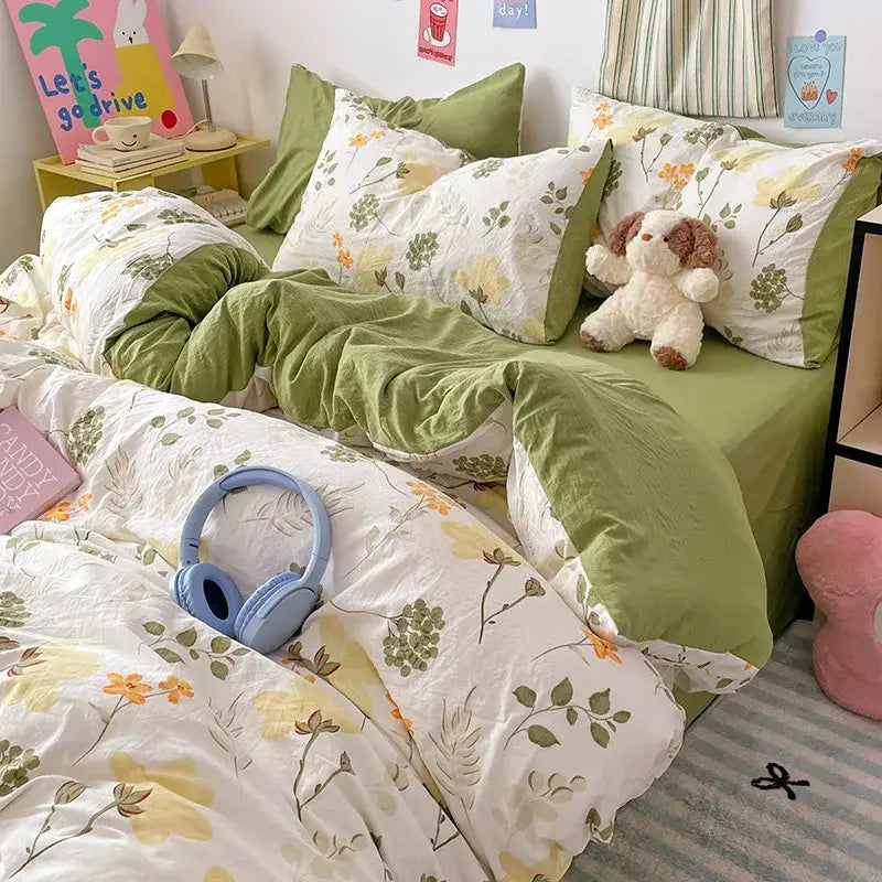 Light blue over-ear headphones resting on pastel blue and white cotton bed sets with bunny cartoon pattern decorbites cartoon pattern