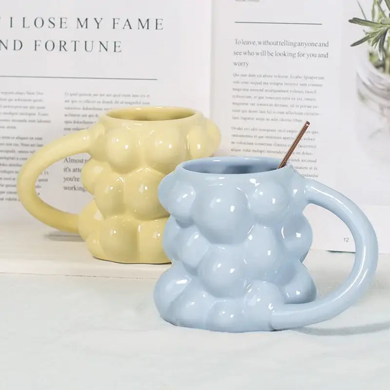 Light blue ceramic mug with textured bubble surface and curved handle from decorbites grape ceramic collection