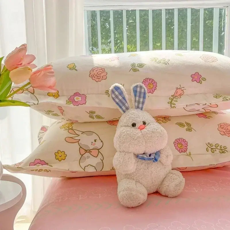 Fluffy white plush bunny with blue plaid ears and bow tie featured in pastel cartoon print bedding set decorbites cartoon print