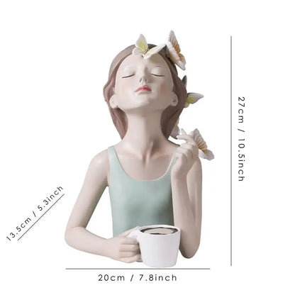 A serene light green butterfly fairy resin figurine with closed eyes holding a white mug on a gold tray decorbites decor