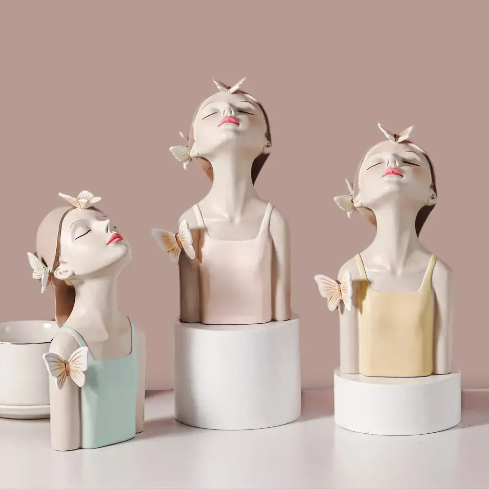 Three elegant pastel-colored butterfly fairy resin figurines with closed eyes on a gold tray for living room decorbites decor