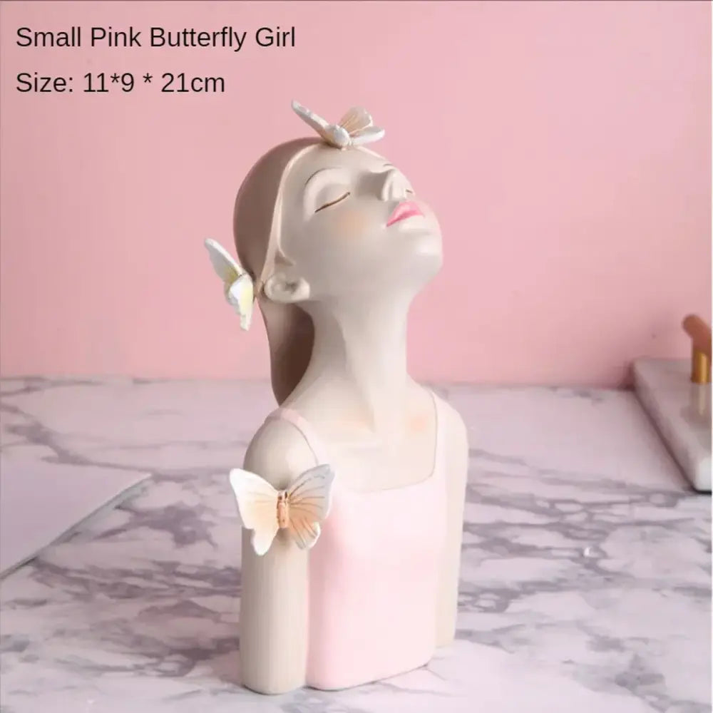 A delicate pastel butterfly girl flower resin ornament with closed eyes pink lips and white butterflies for living room use