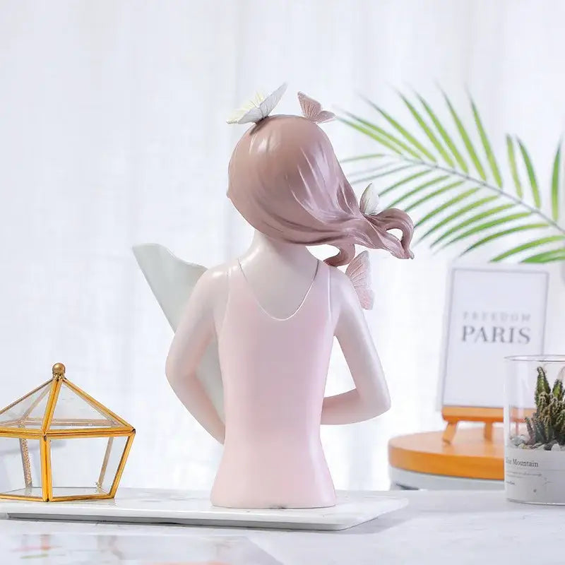 A delicate pink resin butterfly girl figurine with flowing hair and translucent wings for flower vase decor